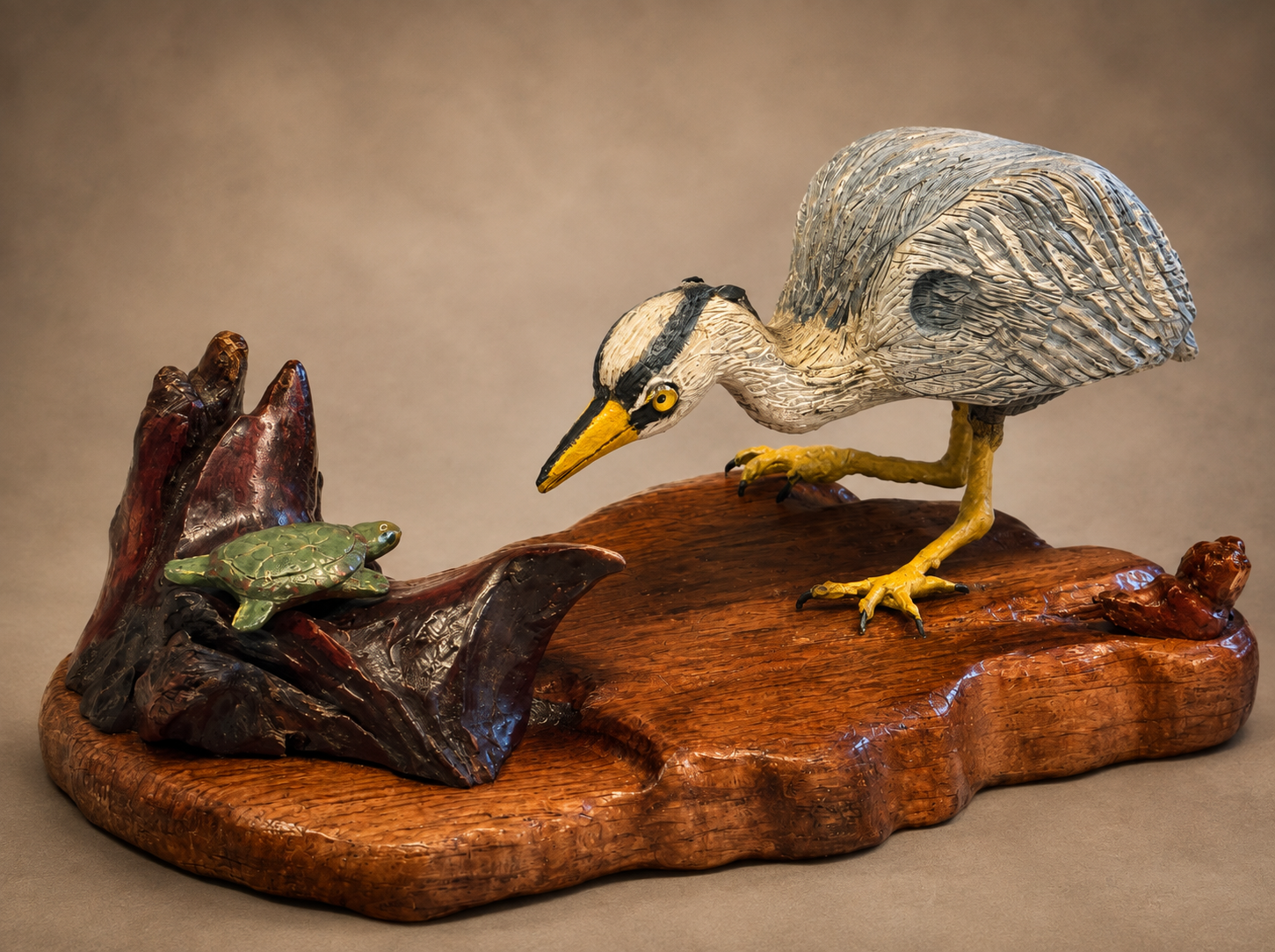 Great blue heron wildlife sculpture with turtle on a carved wood base