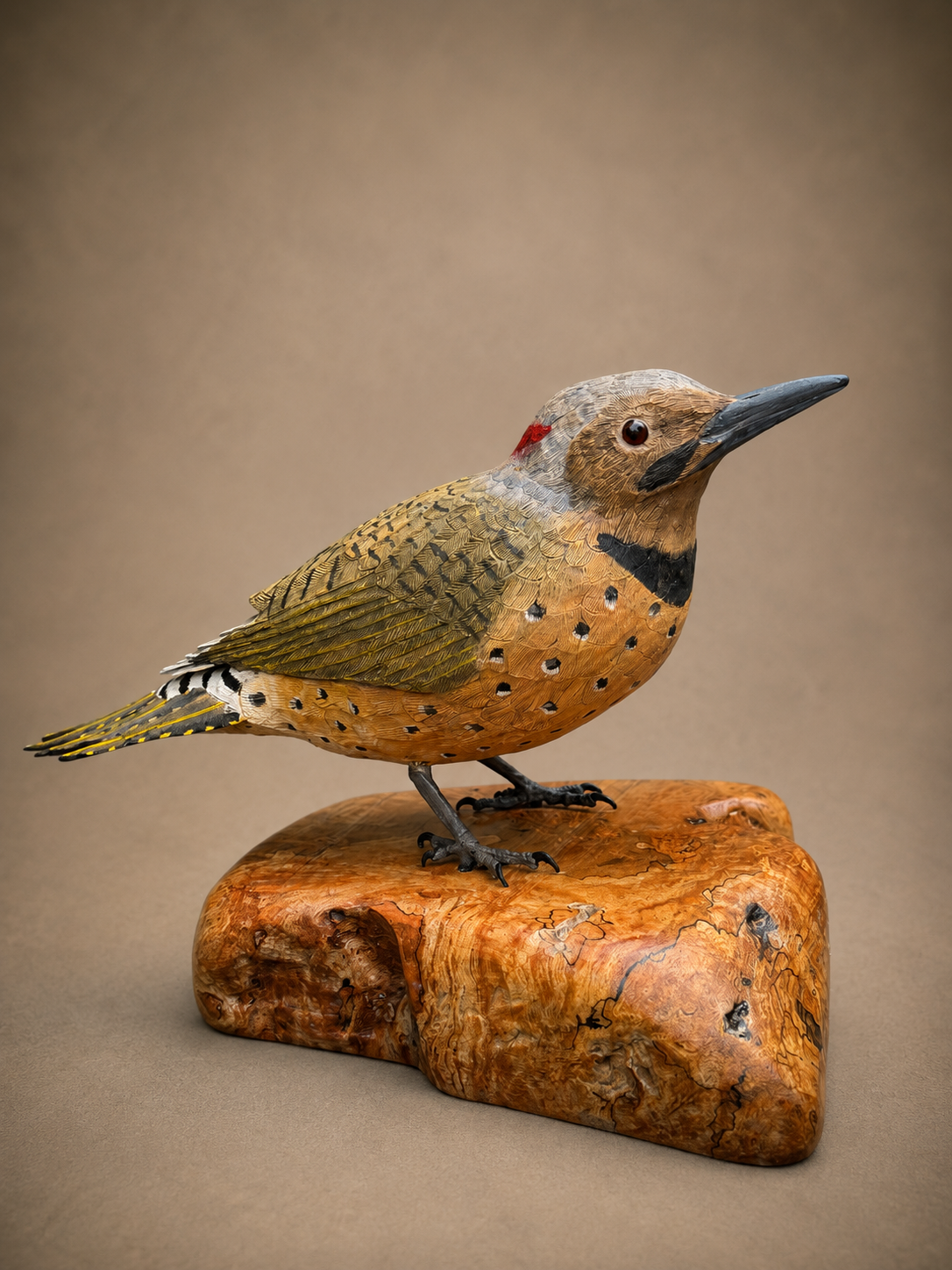 Northern flicker wildlife sculpture on a polished wooden base