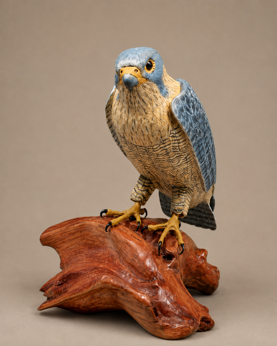 Peregrine falcon wildlife sculpture on a polished wooden base
