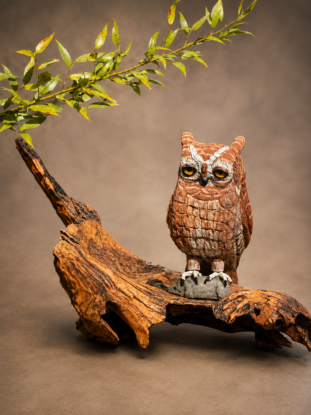 Screech owl wildlife sculpture perched on a natural wood branch